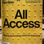 Photo of cover to MIT technology review All Access issue. Image of yellow bumper strip that is in curb cut before crosswalks with various text on top of it