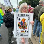 woman holding the discard poster colored in a protest