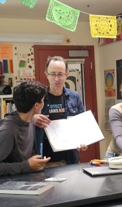 photo of me talking with a student in high school