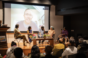 panelists on stage and my image on screen background