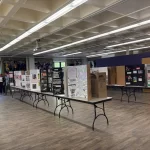photo of room of trifold posters on tables all talking about different comics